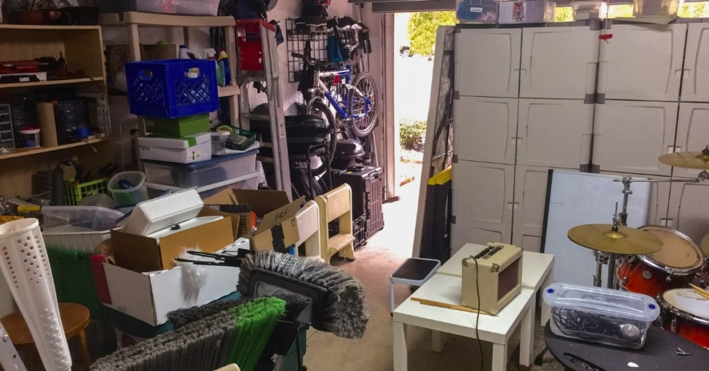 Cluttered garage in Oklahoma City filled with boxes, tools, and storage items.