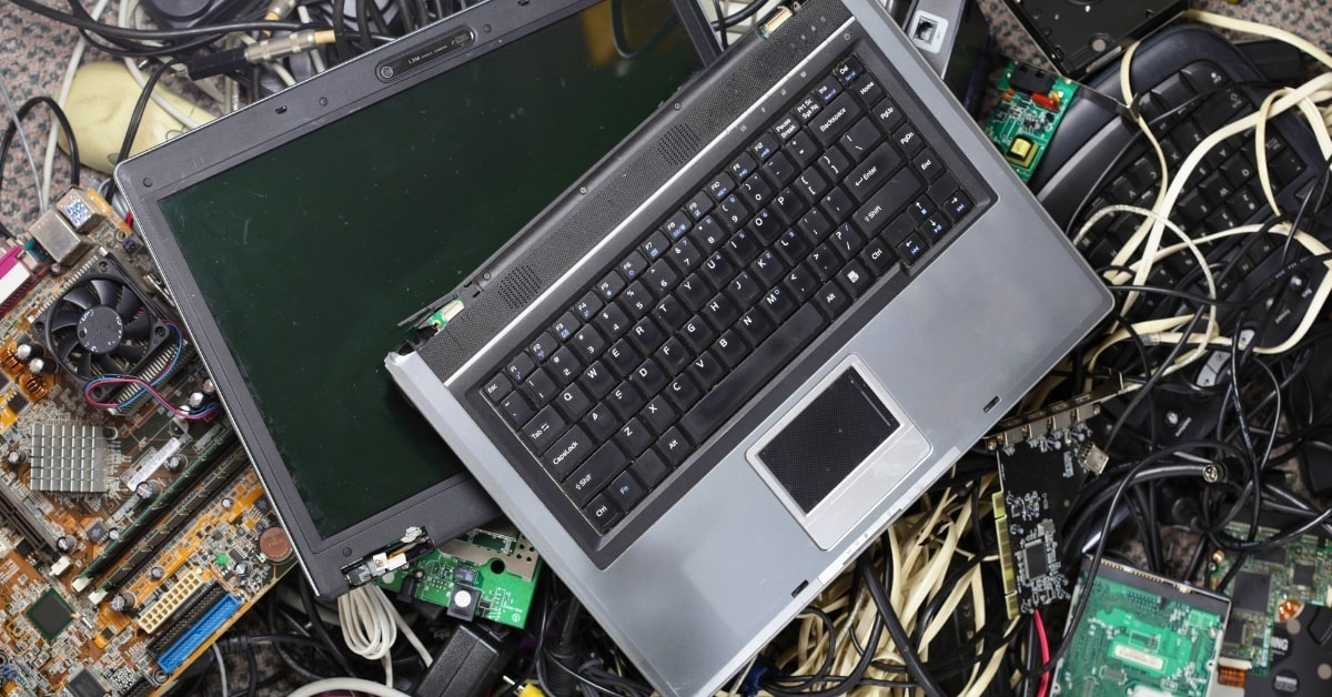 Old laptop and tangled electronics ready for eco-friendly e-waste disposal in Oklahoma City.