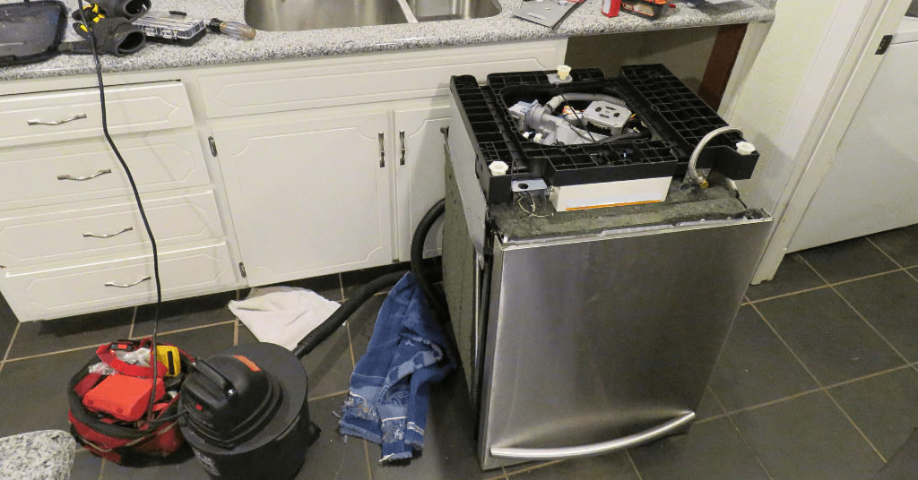 Old dishwasher being removed from a kitchen during appliance disposal service in Oklahoma City, OK.